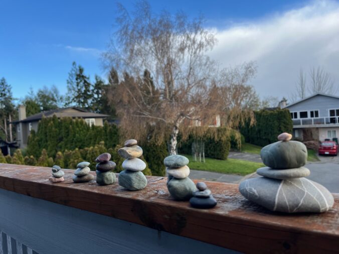Multiple stacks of rocks balancing on top of each other.
